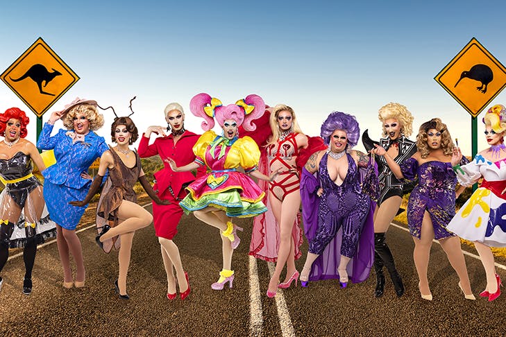 A group of Ru Paul contestants in their outfits on a stretch of Australian outback road.